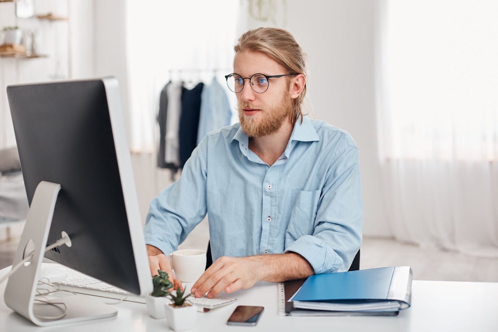 Man with glasses working on computer